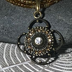Yellow-gold beaded necklace w/ rhinestone pendant